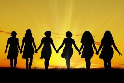 silhouette of women holding hands
